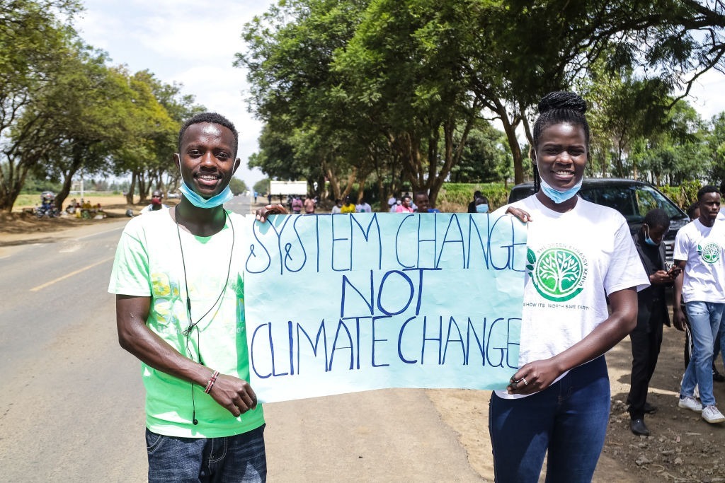 Activists hold a placard